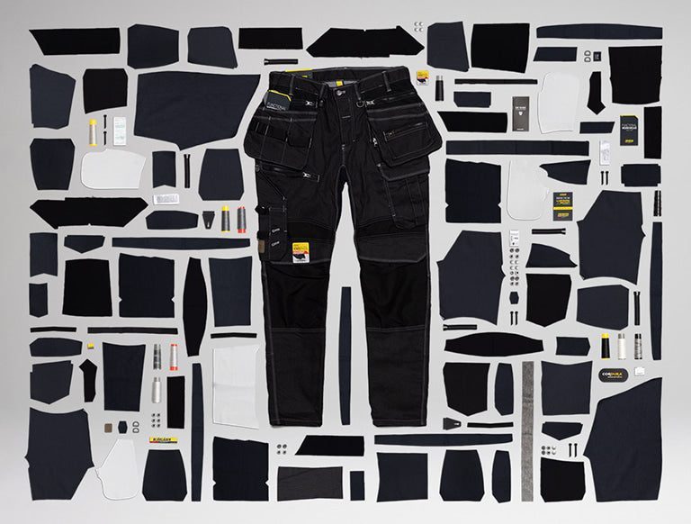Black pants with various patches arranged on a white background